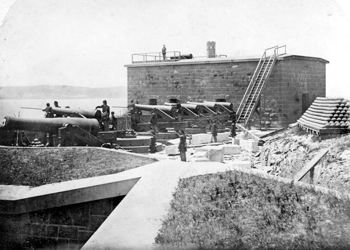 Historic black and white photo of the South Caponier on Alcatraz Island, showing the defensive fortifications with cannons.