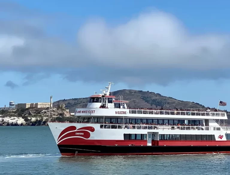 Red and White Fleet's Enhydra hybrid-electric boat sailing in front of Alcatraz Island.
