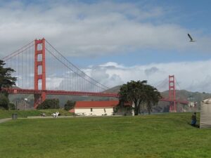 The Golden Gate Bridge viewed from the expansive green lawns of Crissy Field in San Francisco.