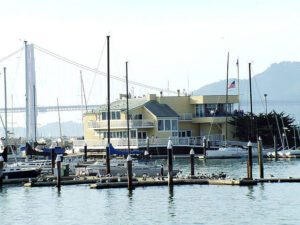 Scenic view of the San Francisco Marina District waterfront with sailboats and coastal architecture.
