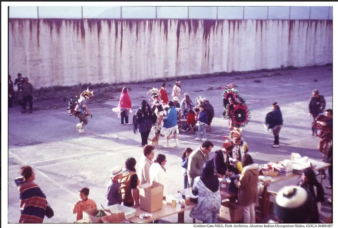 A group of Native American activists and families gathered for a Thanksgiving celebration during the 1969-1971 occupation of Alcatraz Island.