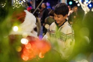 A child enjoying the festive atmosphere at Ghirardelli Square during the holiday season in San Francisco. Copyright Ghirardelli Square Holiday Festivities