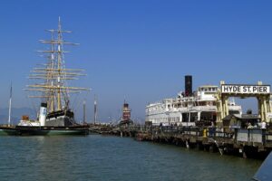 The historic Balclutha sailing ship and Eureka ferry docked at Hyde Street Pier in San Francisco.
